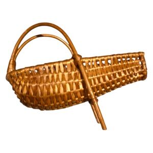 This is a vintage wicker wine bottle holder or pourer caddy.